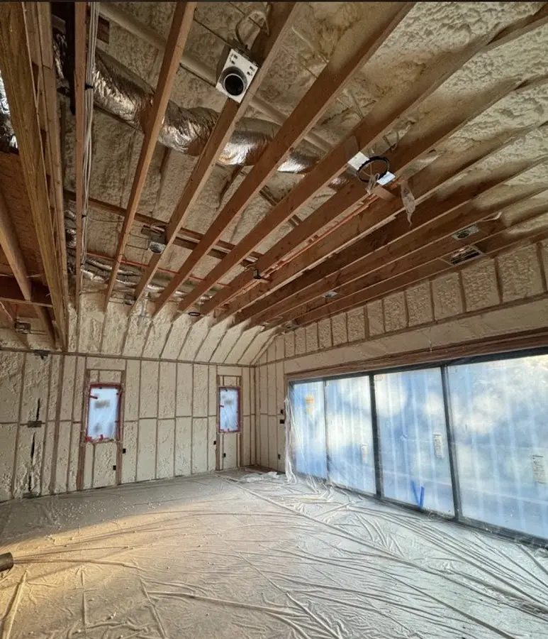 Interior walls and ceiling insulated with spray foam during new construction in Union Mill